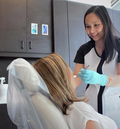 dental hygienist checking patient's teeth