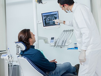 Dentist showing patient x-rays