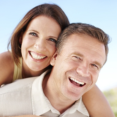 Tysons implant-retained bridge couple smiling