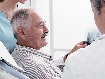 man on a dental chair smiling