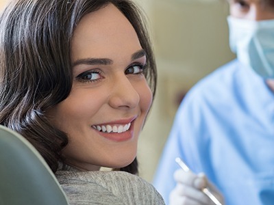 girl smiling while receiving dental checkup