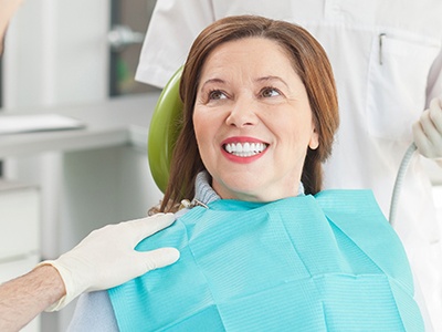 woman with straight and white teeth in a dental chair