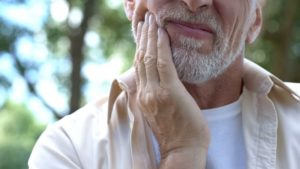 person holding face in pain