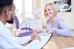 a female patient talking to a dental professional